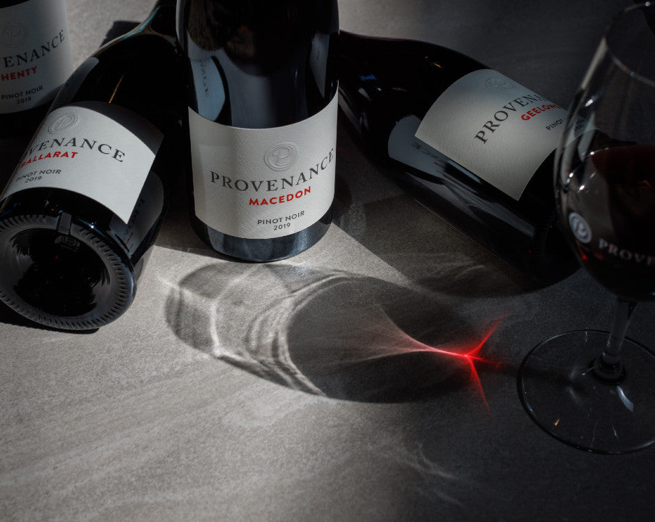 Award winning bottles of wine with a glass of red wine.